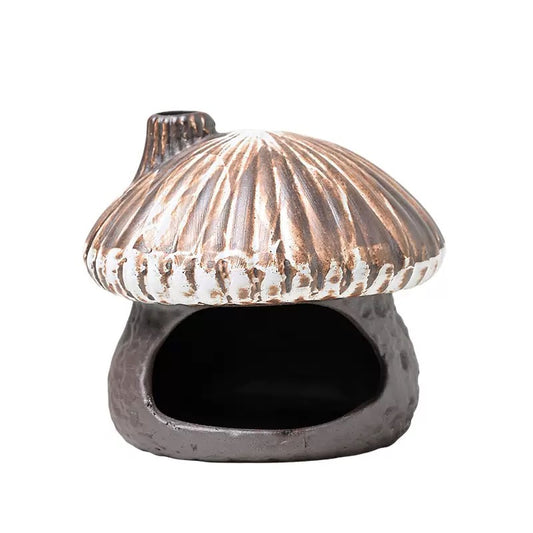 Front view of the rustic ceramic mushroom house incense burner. It features an earthy, textured brown glaze, a wide opening designed to hold Palo Santo, sage bundles, or incense cones, and a miniature chimney on the roof for smoke to escape. Perfect for cottagecore room decor and aromatherapy.