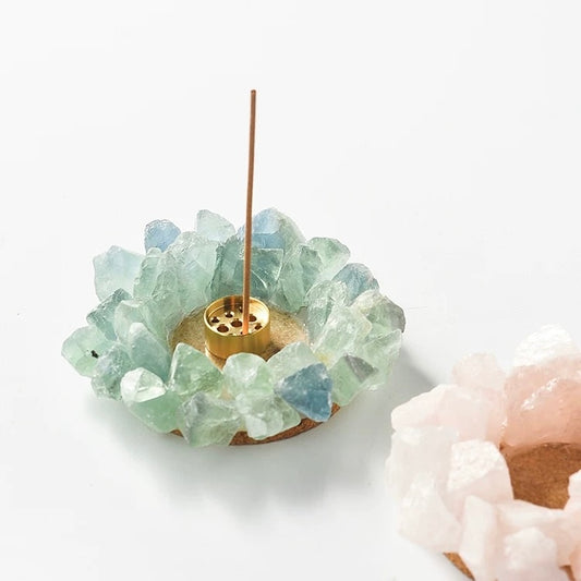 Raw green fluorite crystal incense holder with brass insert holding an incense stick