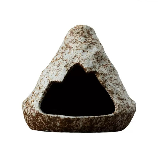 Handmade ceramic incense burner in a cave-inspired triangular stone shape, featuring a rustic speckled surface and hollow center, displayed on a clean white background.