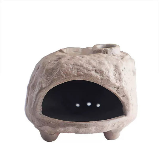 Handmade ceramic incense burner with a rustic stone-like texture, featuring a wide front opening, four short feet, and a recessed top groove, displayed against a clean white background.