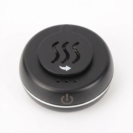 Black portable electric car incense burner with a round compact body, vented rotating top cover, three indicator lights, and a front power symbol, shown on a white background.