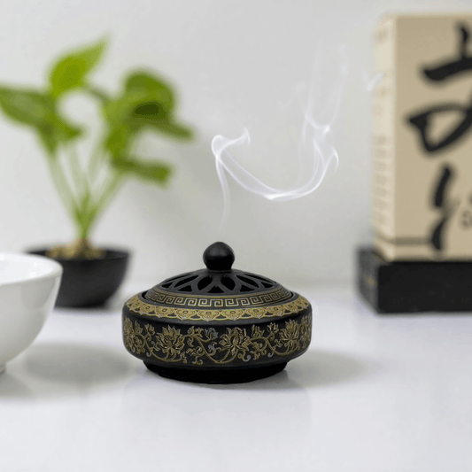 Antique cloisonné incense burner with a domed cut-out lid, featuring gold floral patterns on black enamel, suitable for incense powder and cones.