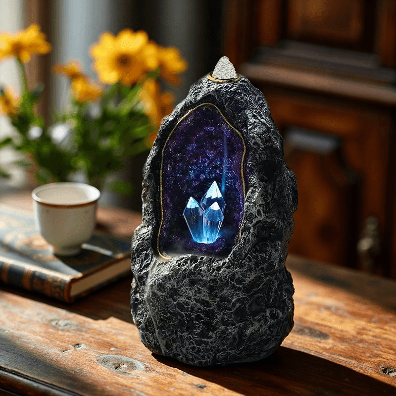 LED geode backflow incense burner placed on wooden table with flowers in the background for cozy decor.