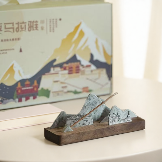 Mountain-shaped incense burner with Tibetan incense stick and scenic background