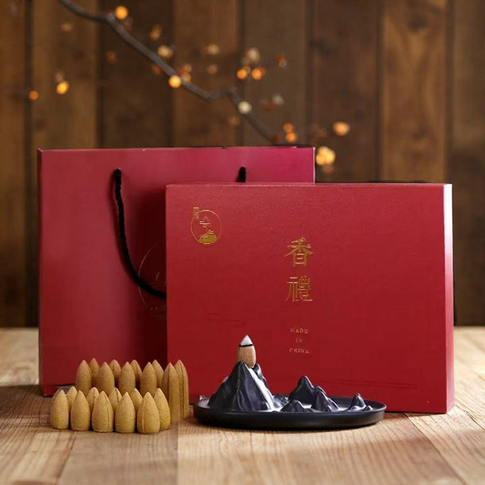 Red gift box and matching bag with a ceramic mountain backflow incense burner and agarwood cones