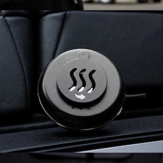 Close-up of portable car incense burner with metal top featuring steam wave icon, installed on car dashboard for aromatherapy use