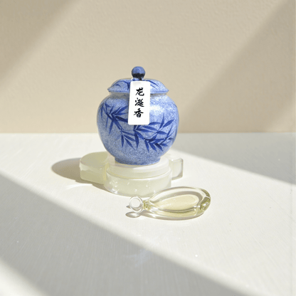 Ambergris incense powder in a blue hand-painted ceramic jar with white label and black text