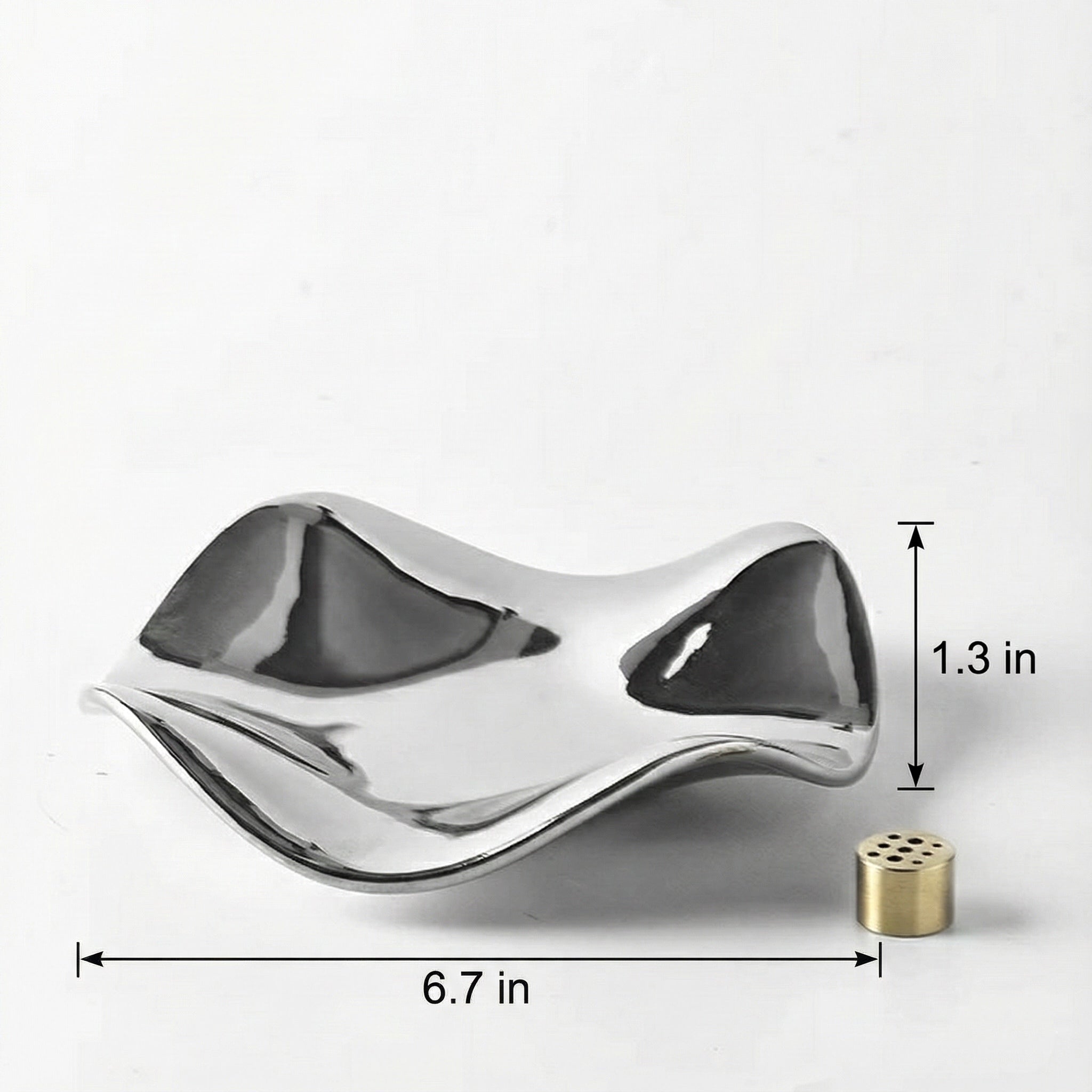 Close-up of a hand inserting an incense stick into the brass holder centered on a silver wave tray. The image demonstrates the ease of use and the multi-hole design.