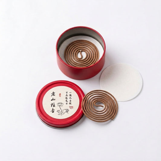 Aged sandalwood incense coils in an open red tin with pre-separated single coils and protective insert on a white background