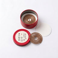 Aged sandalwood incense coils in an open red tin with pre-separated single coils and protective insert on a white background