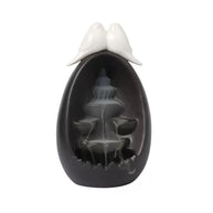 Front view of the Backflow Incense Burner Ceramic Waterfall with Doves, featuring a black ceramic waterfall design with two dove figures on top and tiered backflow channels for cascading incense smoke