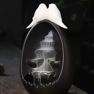 Backflow Incense Burner Ceramic Waterfall with Doves styled on a rustic wooden surface, featuring two white doves on top and a flowing incense smoke waterfall against a moody background with soft blue lights
