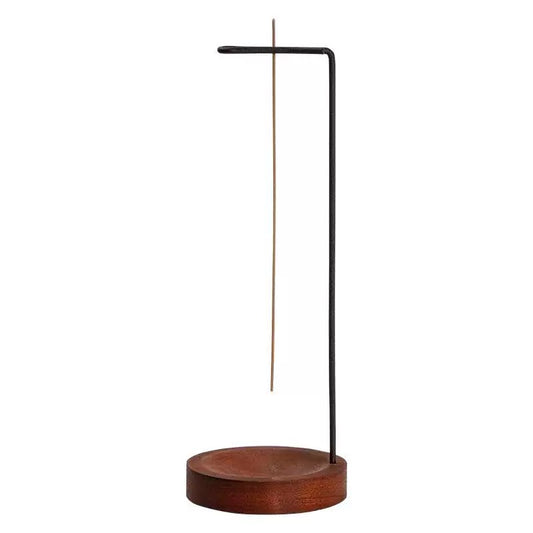 Minimalist hanging stick incense holder with a black metal stand, suspended incense stick, and round wooden base on a clean white background.