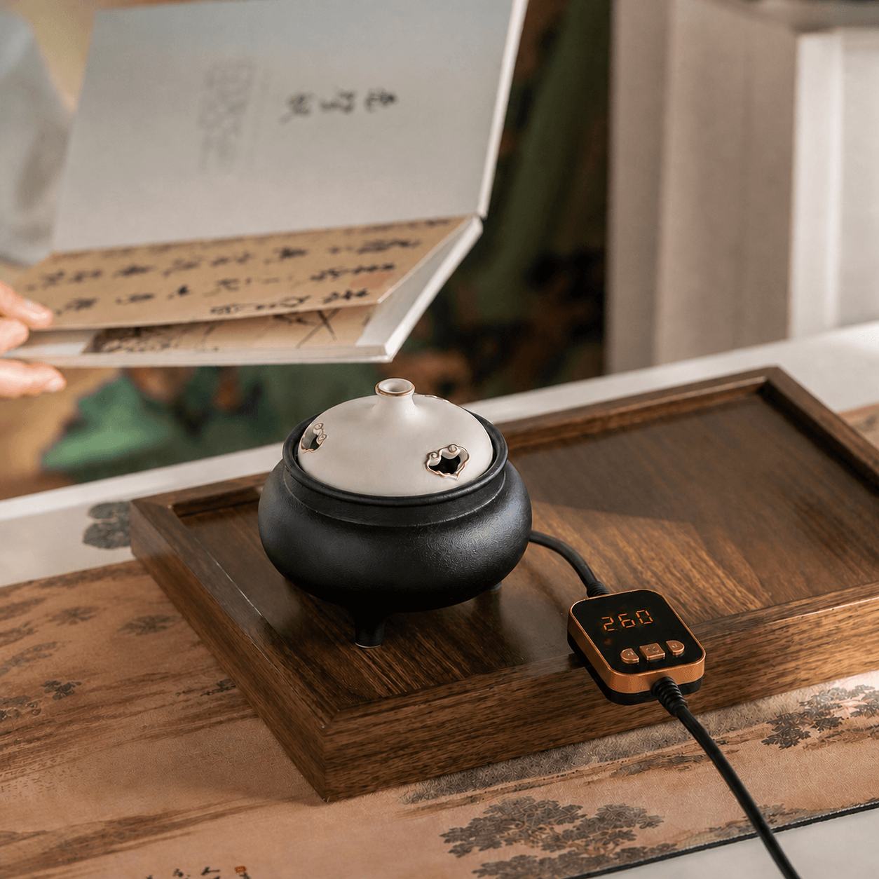 Black and white ceramic electric incense burner with temperature controller on a wooden tray, shown with gift packaging for flameless incense heating.