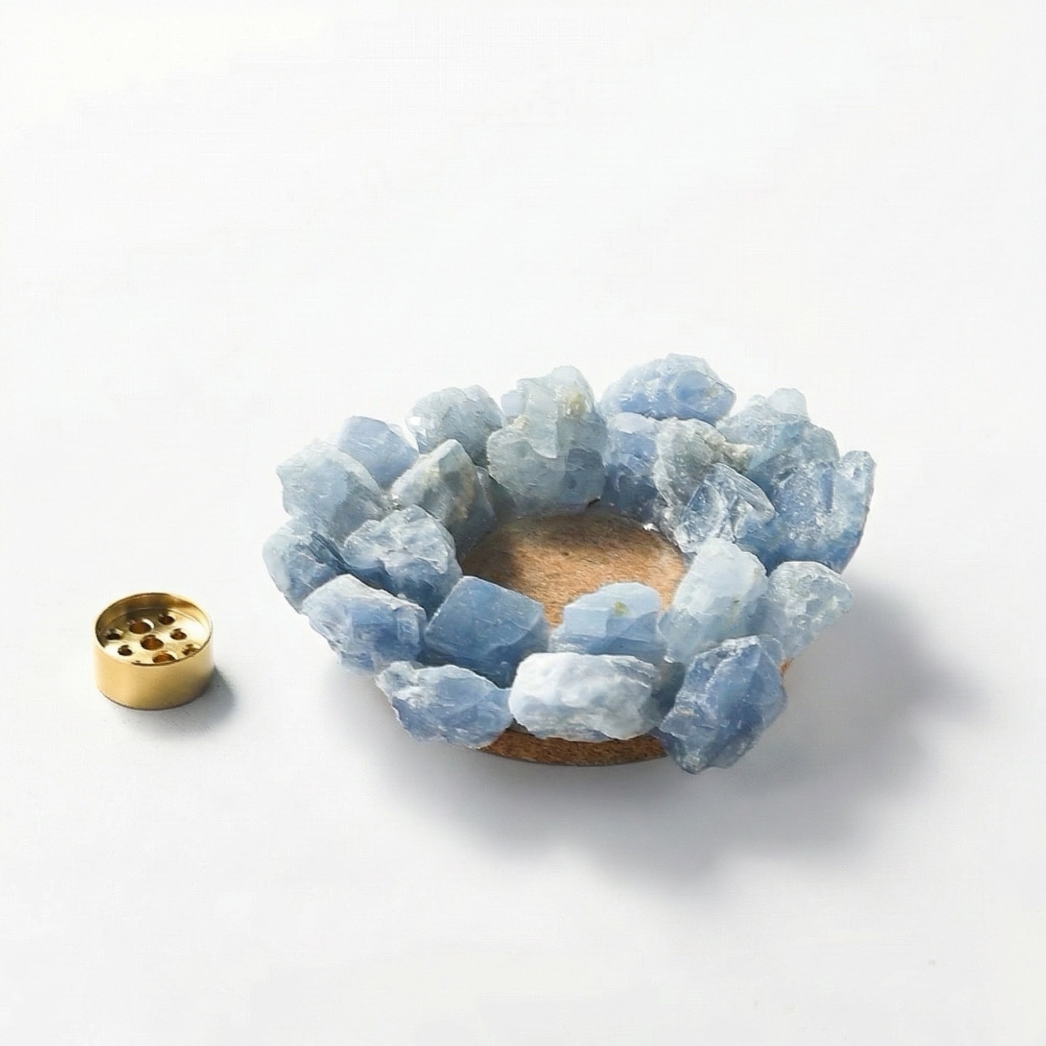 Raw blue quartz crystal incense holder ring with removable brass insert displayed separately on white background