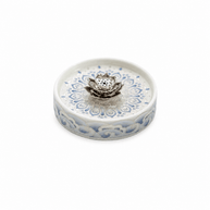 Round blue and white ceramic incense holder with a raised lotus centerpiece and floral pattern on a white background