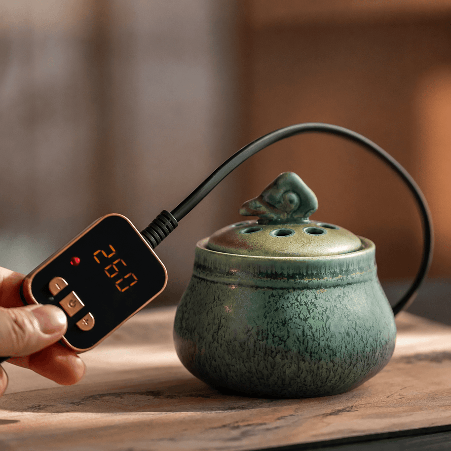 Ceramic electric incense burner with handheld temperature controller for flameless aroma heating, adjustable heat control, and everyday home fragrance use.