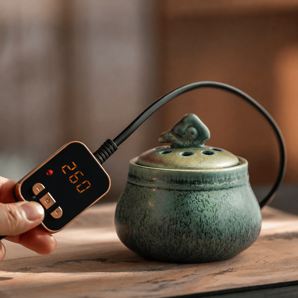 Ceramic electric incense burner with handheld temperature controller for flameless aroma heating, adjustable heat control, and everyday home fragrance use.