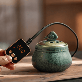 Ceramic electric incense burner with handheld temperature controller for flameless aroma heating, adjustable heat control, and everyday home fragrance use.