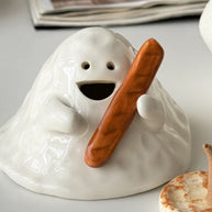 Hand-painted ceramic ghost incense holder for cone incense, glossy white with matching base on a tabletop, lifestyle scene.