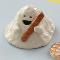 Hand-painted ceramic ghost incense holder for cone incense, glossy white with matching base, top view on a light background.