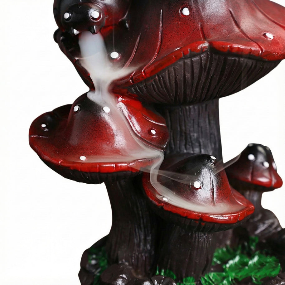 Front detail view of the creative resin mushroom backflow incense burner showing white smoke cascading down the red mushroom caps like a misty waterfall against a white background.