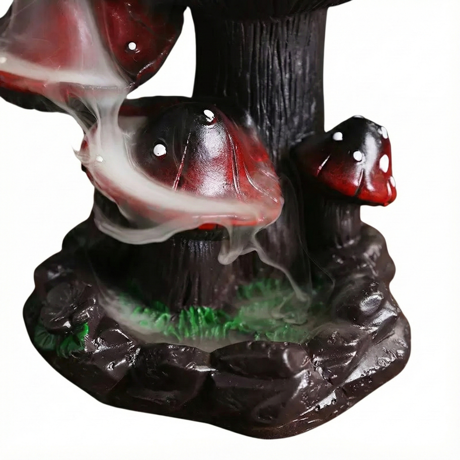 Close up detail of white smoke cascading down the red mushroom caps and pooling on the dark base against a white background.