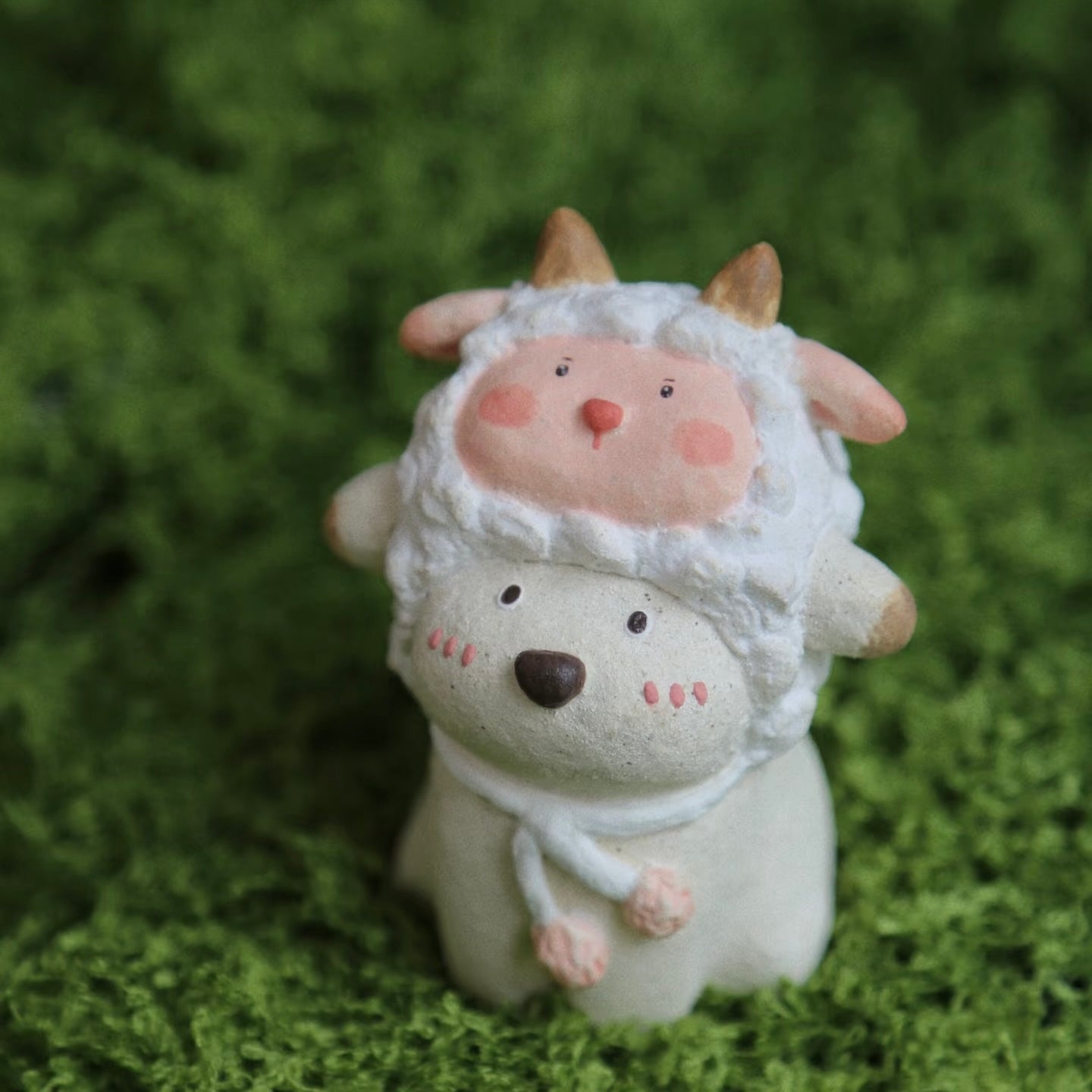 Custom handmade ceramic incense holder featuring a cute bear in a sheep costume, shown in a close-up view on green moss with a soft natural background