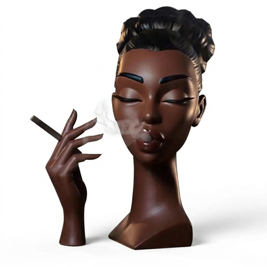 Dark brown resin incense burner shaped like a woman’s bust with closed eyes and a separate sculpted hand holding an incense stick, with smoke drifting softly from her lips against a white background.