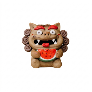 Handcrafted ceramic Pixiu backflow incense burner tea pet featuring a playful mythical beast with red eyebrows, curly mane, and a watermelon held in its paws, shown on a clean white background.