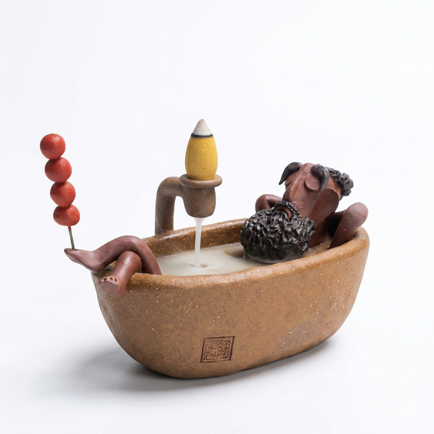 Handmade ceramic backflow incense burner featuring The Relaxing Sage reclining in a bathtub with cascading smoke and an incense cone on a white background