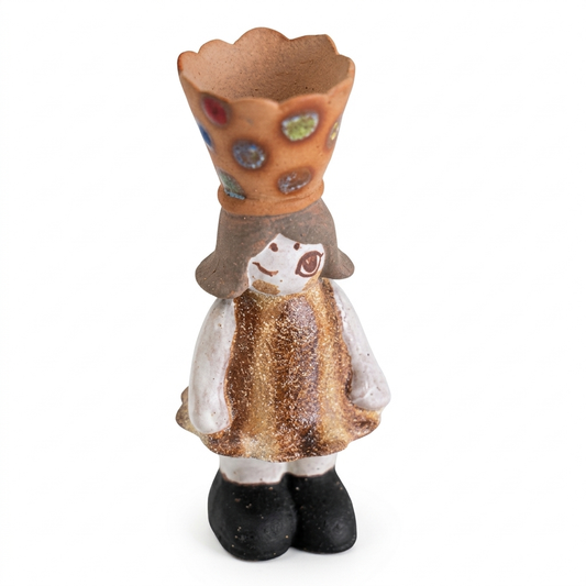 Handmade ceramic crowned girl incense burner figurine with a warm brown dress, white sleeves, black shoes, and a scalloped crown cup decorated with colorful jewel-like accents, shown against a white background.