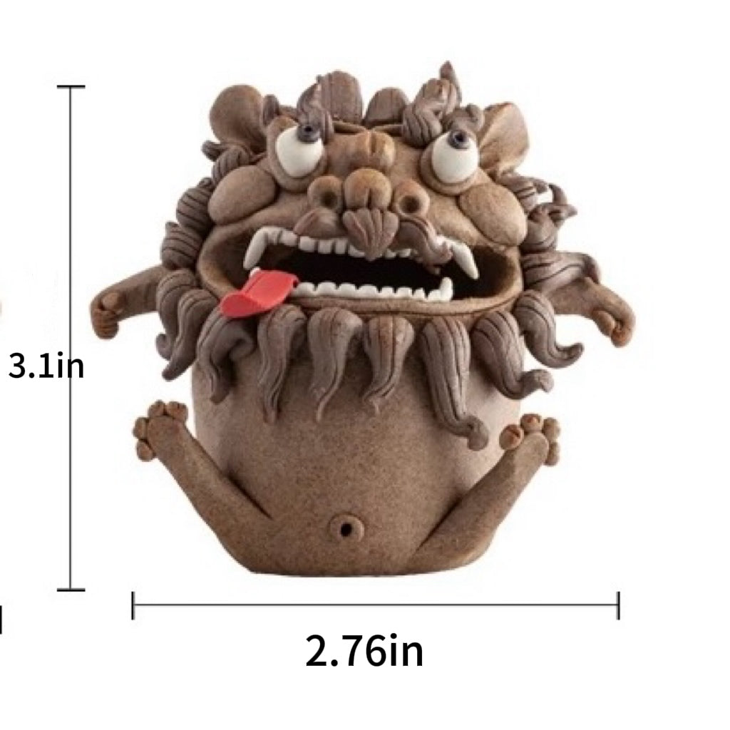 A striking front view of the handmade ceramic guardian beast backflow incense burner with smoke actively pouring from its open mouth, creating a mesmerizing smoke waterfall effect. The detailed monster figure, featuring its expressive eyes, maned-like texture, and small hands, is shown against a plain white background. This functional art piece showcases the calming smoke river cascading to a misty pool below, perfect for creating a mystical atmosphere on a meditation desk or as a unique tea table protector