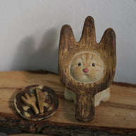 Handmade ceramic incense holder shaped like The Hungry Foodie Cat displayed on a rustic wood surface with a matching ash tray featuring fork and knife details