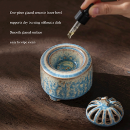 Electric incense burner with timer and handmade ceramic heater in blue glaze, shown with the lid removed to display the one-piece glazed inner bowl for essential oils, resin, and dry incense use on a wooden surface