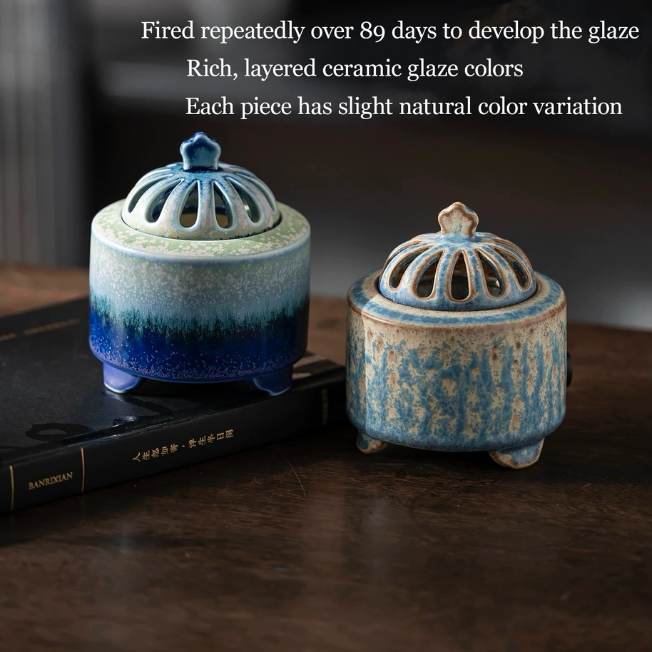 Electric incense burner with timer and handmade ceramic heater shown in two ceramic glaze color options, featuring layered blue gradient and speckled blue finishes on a wooden tabletop
