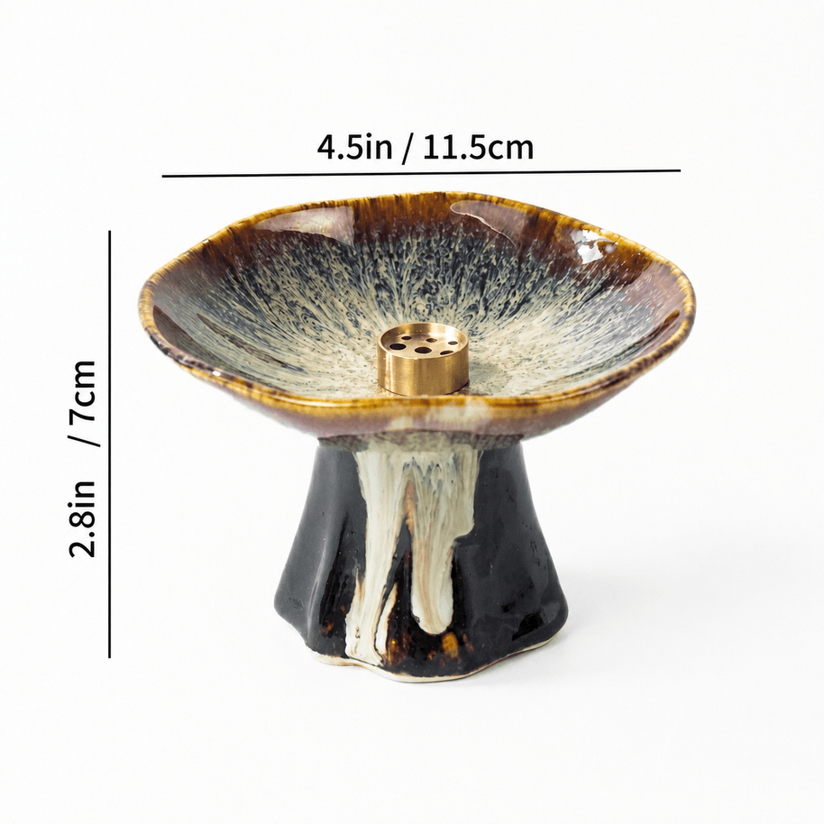 Japanese wabi-sabi style pedestal ceramic incense holder with reactive brown glaze and brass insert, showing size dimensions 4.5 in wide and 2.8 in high on a white background.
