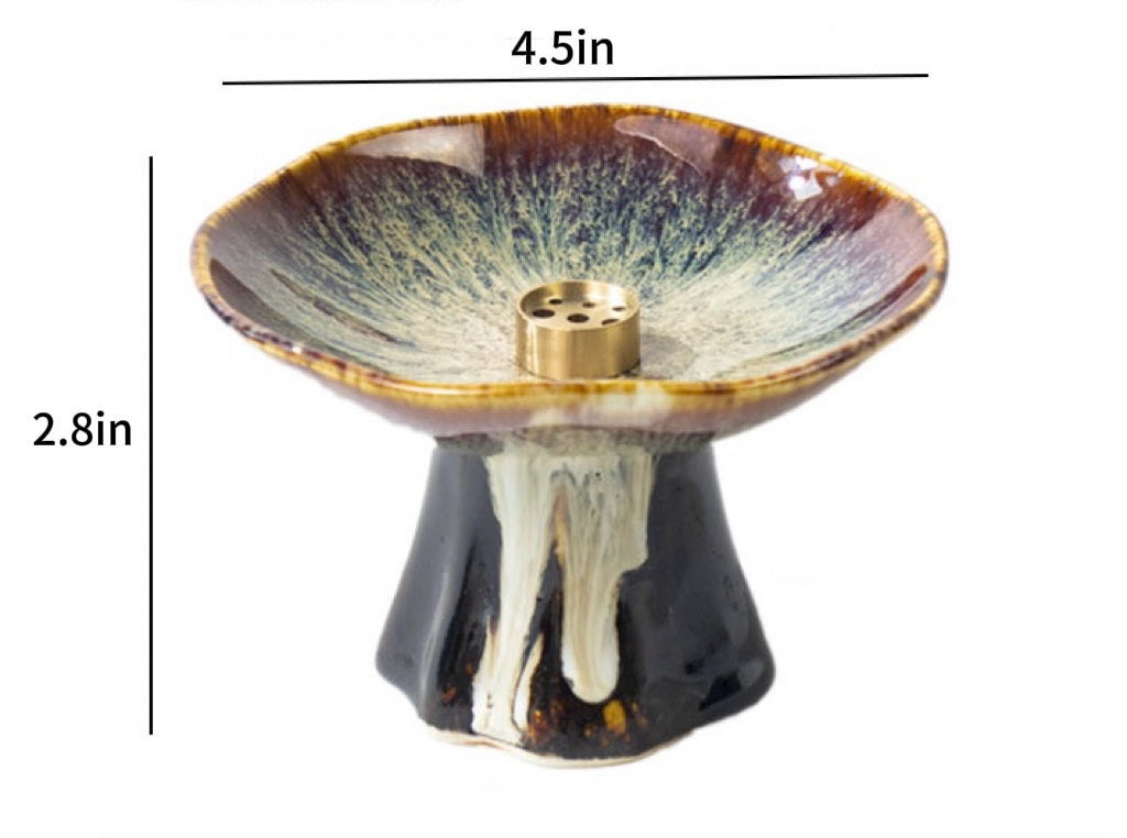 Japanese wabi-sabi style pedestal ceramic incense holder with reactive brown glaze and brass insert, showing size dimensions 4.5 in wide and 2.8 in high on a white background.