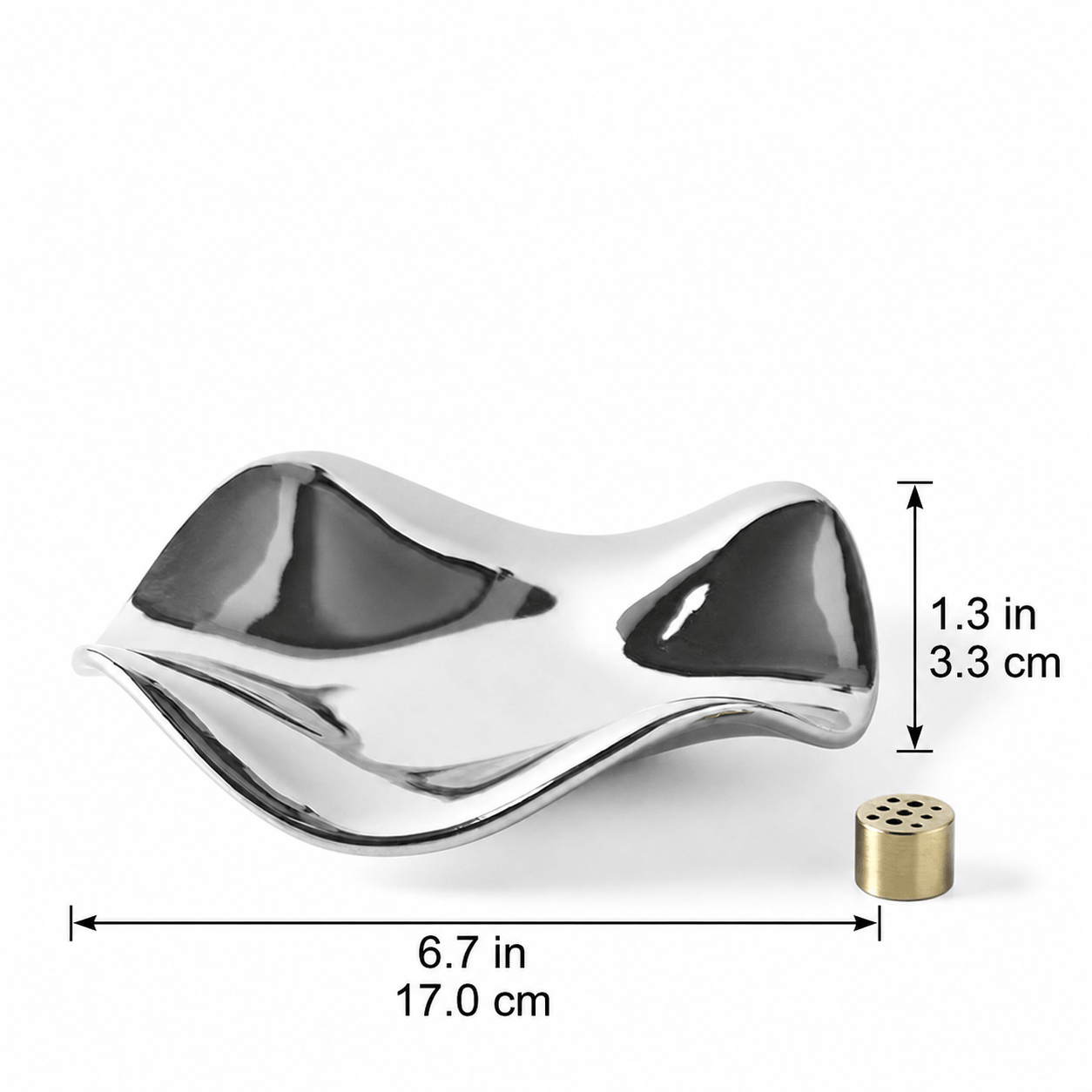 Close-up of a hand inserting an incense stick into the brass holder centered on a silver wave tray. The image demonstrates the ease of use and the multi-hole design.