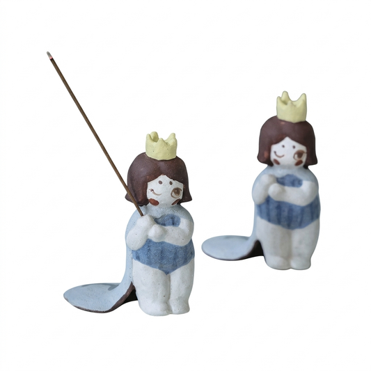 Little Girl Raw-Ore Ceramic Incense Holder in a hand-pinched coarse pottery figurine design, featuring a crowned girl in a blue dress shown in two views, with one holding a stick incense on a clean white background.