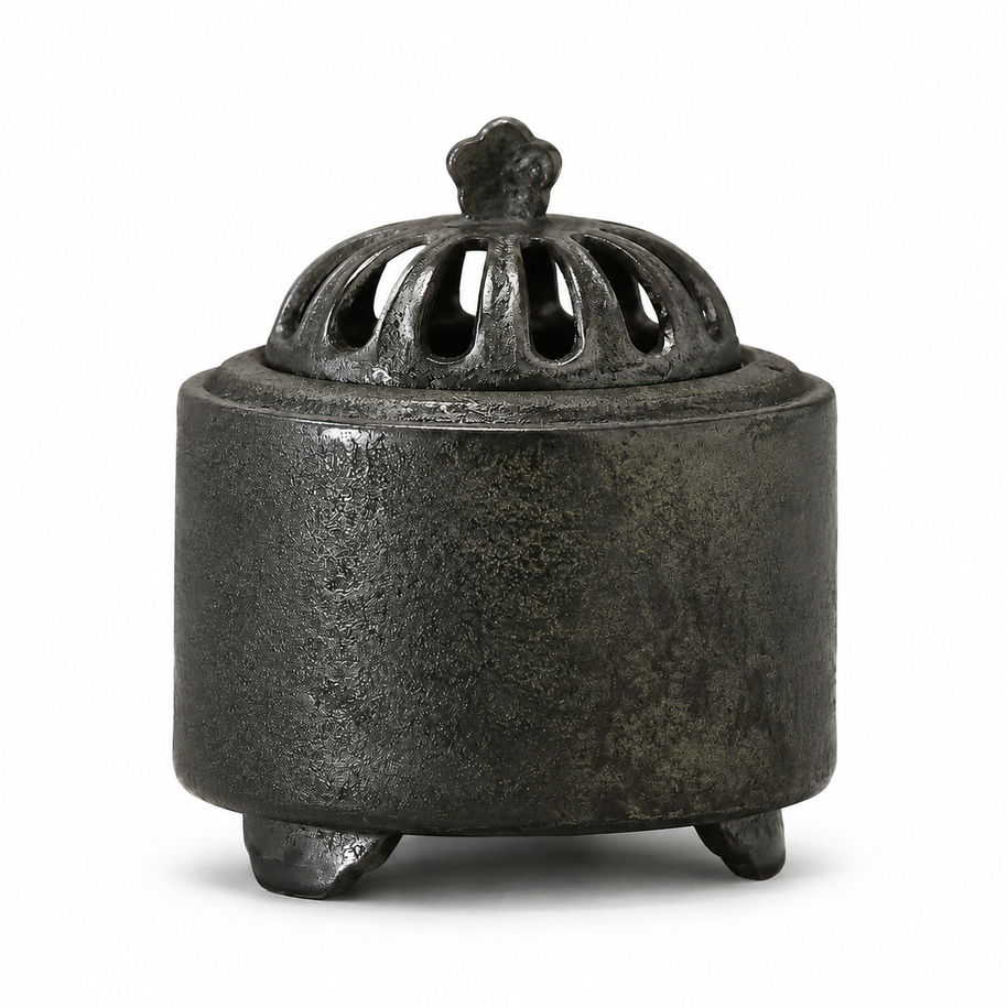Obsidian black ceramic electric incense burner with a textured finish and vented dome lid displayed on a white background