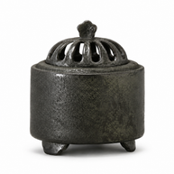 Obsidian black ceramic electric incense burner with a textured finish and vented dome lid displayed on a white background