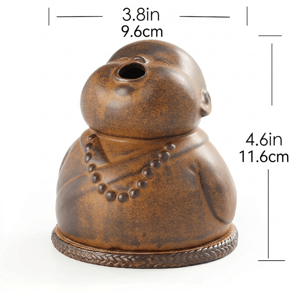 Peaceful Little Monk Incense Burner shown with size markings of 3.8 in / 9.6 cm width and 4.6 in / 11.6 cm height, featuring a brown ceramic monk design with a smoke outlet and prayer bead details.