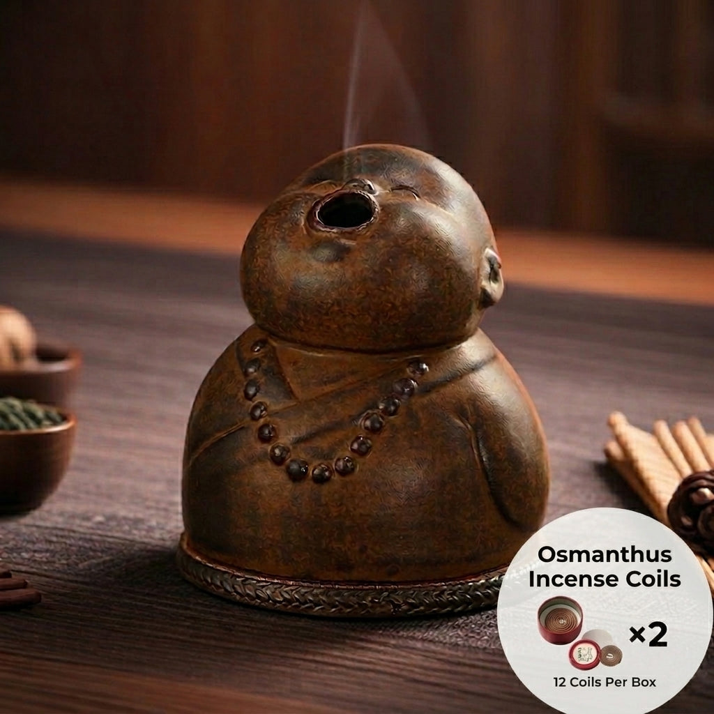 Peaceful Little Monk Incense Burner displayed on a wooden surface with osmanthus incense coils included, featuring a brown ceramic monk figure with a smoke outlet and prayer bead details.