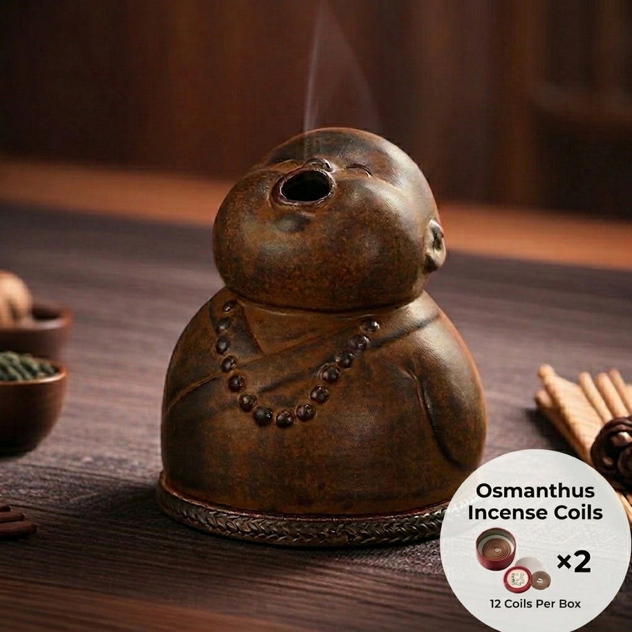 Peaceful Little Monk Incense Burner displayed on a wooden surface with osmanthus incense coils included, featuring a brown ceramic monk figure with a smoke outlet and prayer bead details.