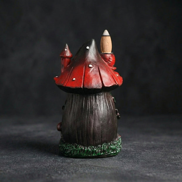 Rear view of the resin mushroom backflow incense burner, detailing the textured dark brown base, vibrant red spotted cap, and an incense cone resting on top. Perfect for whimsical home decor.