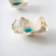 Side profile of the Sea Blossom handmade ceramic incense holder featuring organic sculpted edges, a coastal-inspired white clay finish, and a vivid blue glaze center on a clean white background