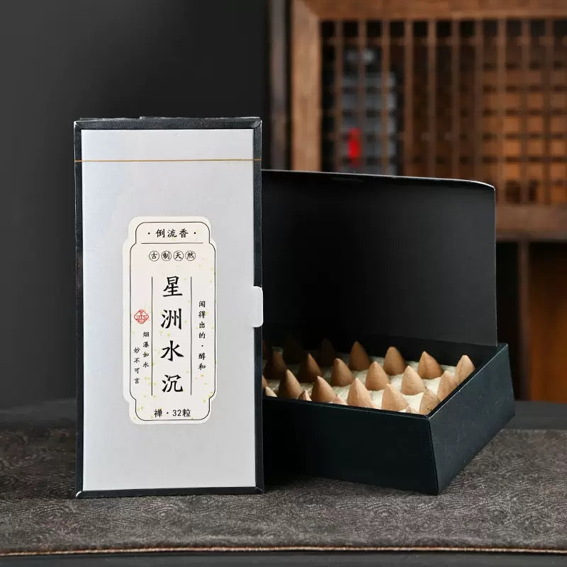 Water aloes backflow incense cones in a black box with resinous agarwood style packaging for waterfall incense burner