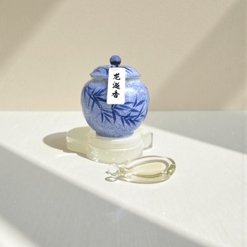 Ambergris handcrafted natural incense powder in a blue ceramic jar, made from aged ambergris.