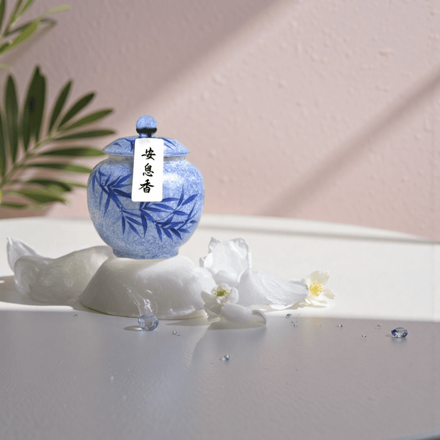 Anxi handcrafted natural incense powder in a blue ceramic jar, formulated to support restful sleep and calming rituals.